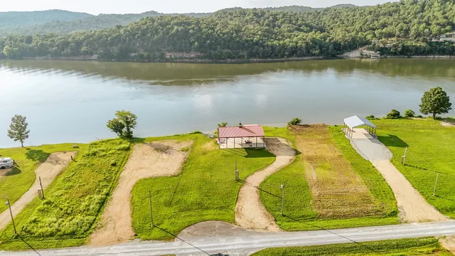 a bed sitting in a bedroom next to a lake view