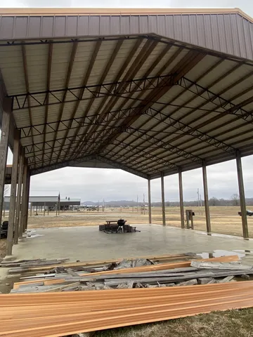 a view of a road with a yard and large trees