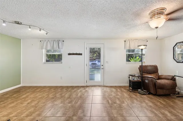 a view of room with workspace and windows