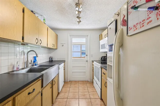 a kitchen with a sink stove and refrigerator