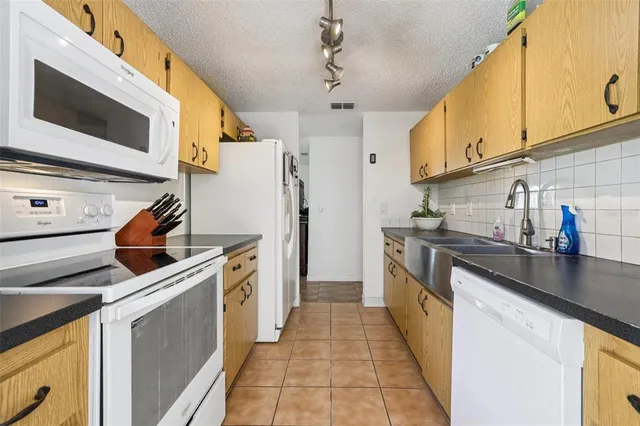 a kitchen with stainless steel appliances granite countertop a refrigerator and a stove