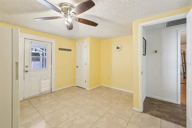 a view of a livingroom with a chandelier fan