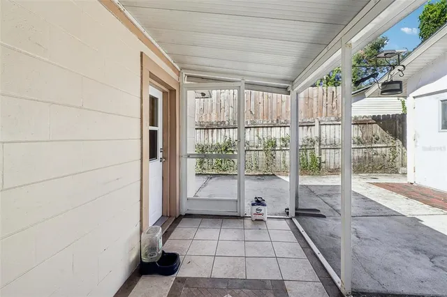 a bathroom with a bathtub and next to a window