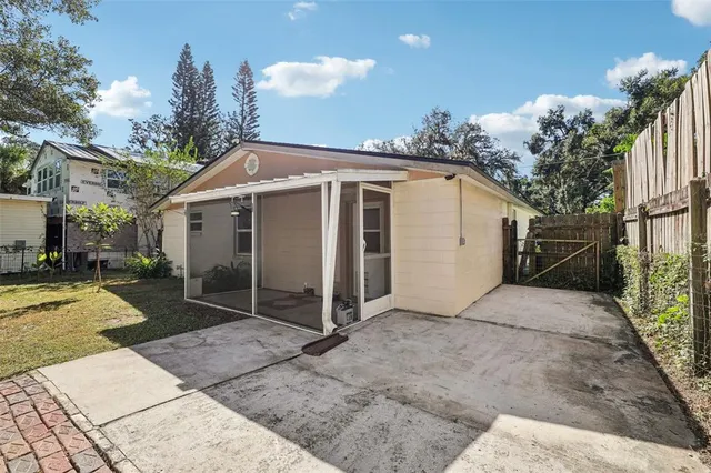 a view of a house with a yard and potted plants