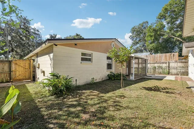 a backyard of a house with table and chairs