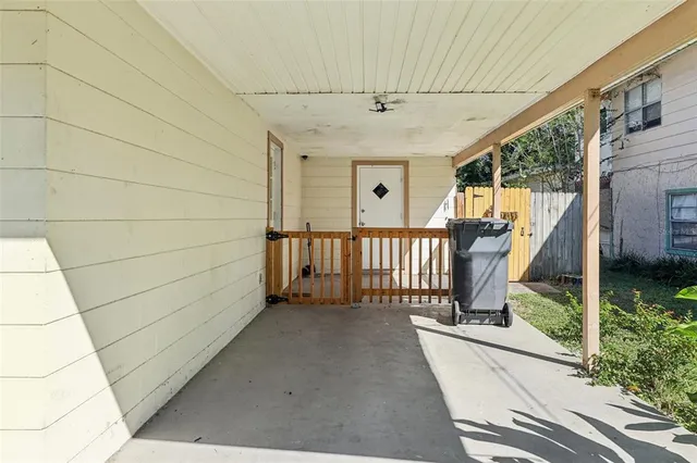 a view of a porch with wooden floor and iron fence