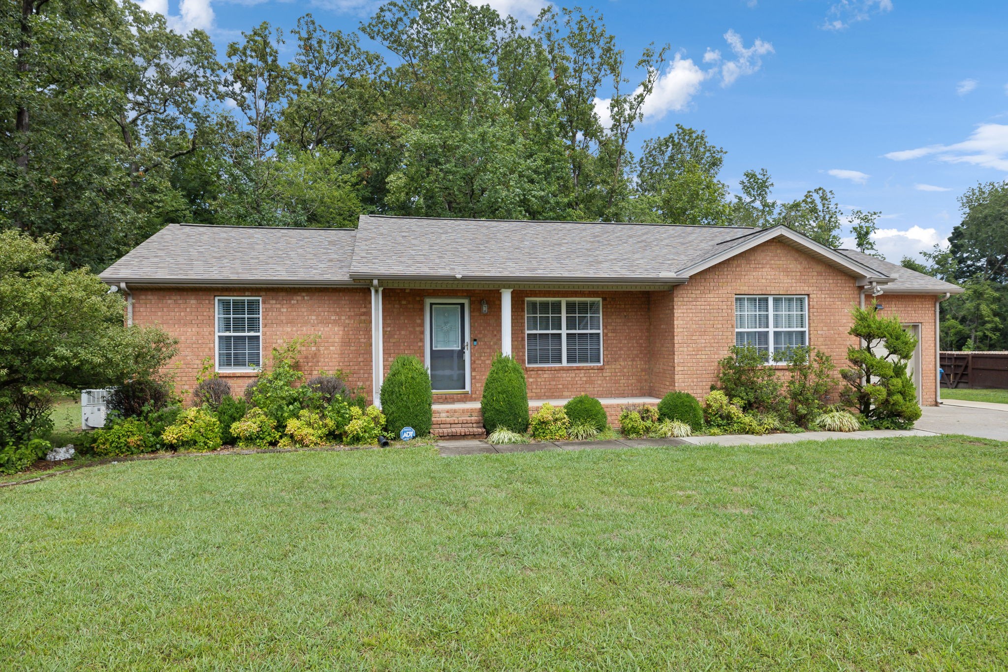 373 Oak Hollow Road Manchester, TN 37355 - Photo 1 of 34 a front view of a house with a yard and garage