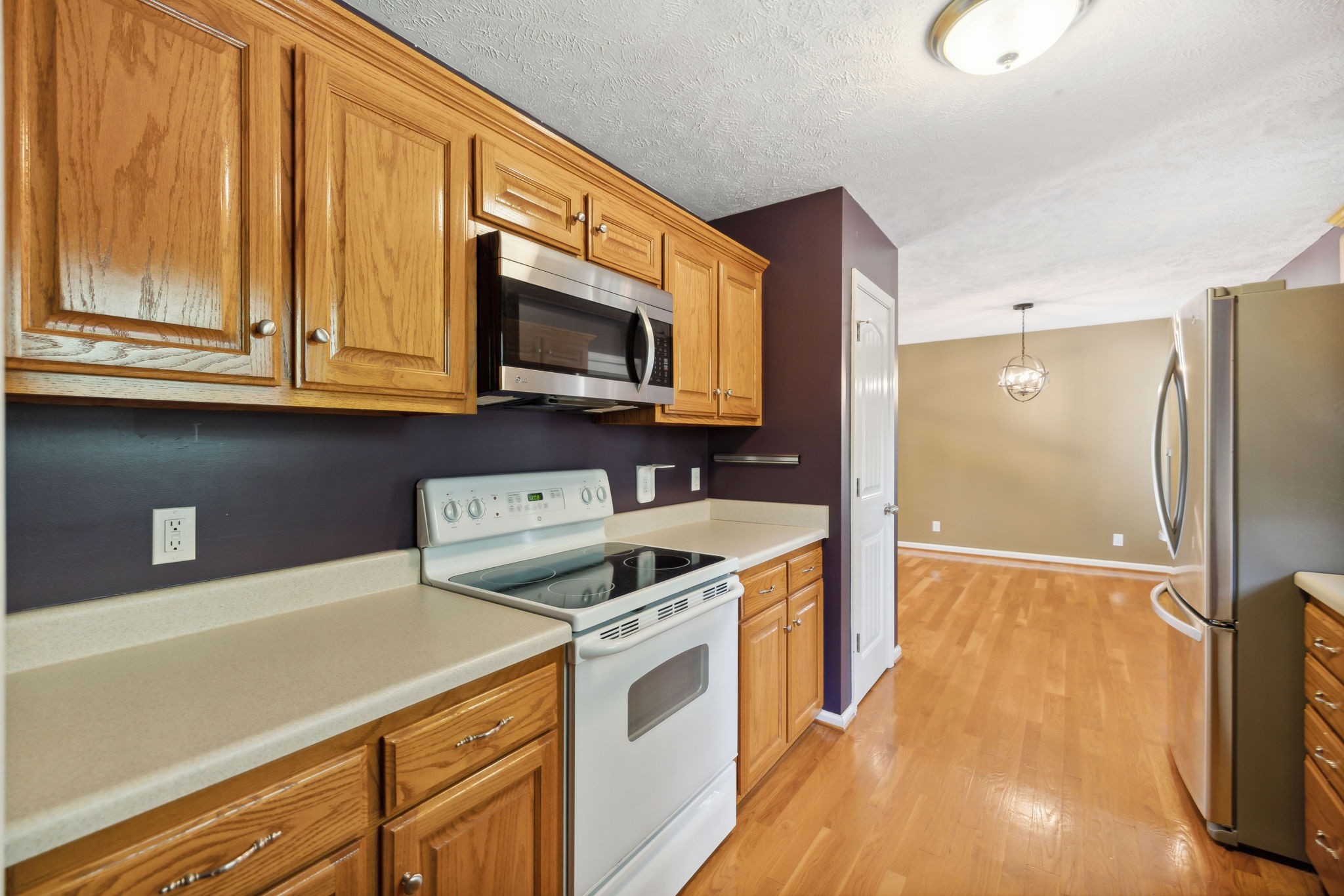 373 Oak Hollow Road Manchester, TN 37355 - Photo 12 of 34 a kitchen with stainless steel appliances a stove a microwave and a hard wood floors