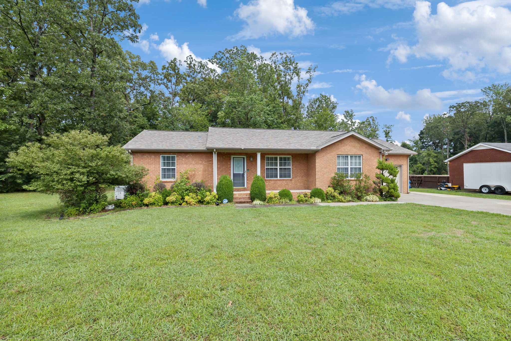 373 Oak Hollow Road Manchester, TN 37355 - Photo 2 of 34 a front view of a house with a yard and trees