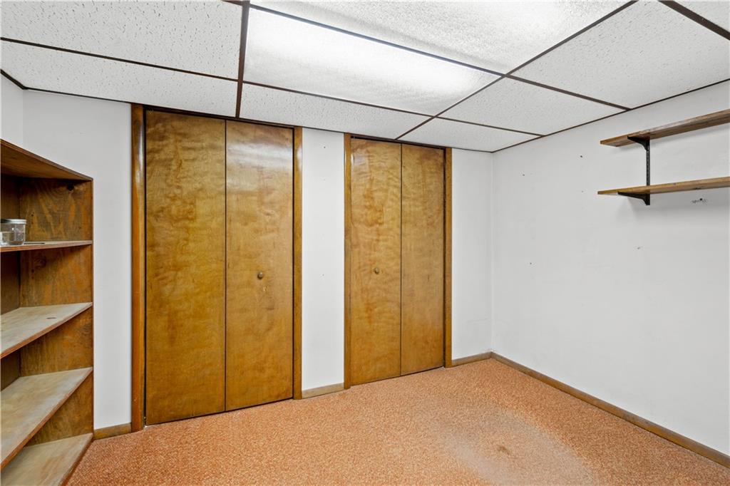 105 Deer Run Road Washington, PA 15301 - Photo 24 of 25 The basement has a home office or potential 4th bedroom that boasts large, double closets and additional shelving.