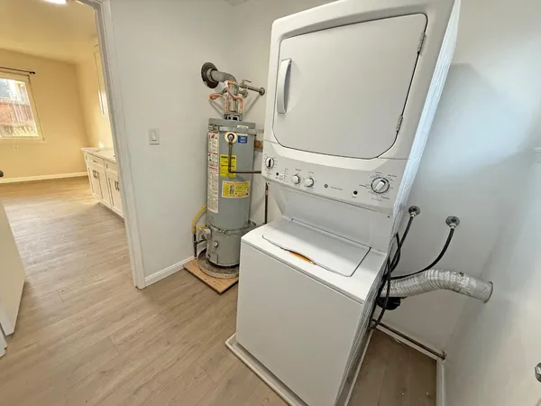 a kitchen with granite countertop white cabinets and a sink