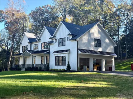 a front view of a house with a yard and porch