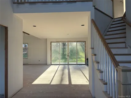 a view of outdoor space with wooden floor and white walls