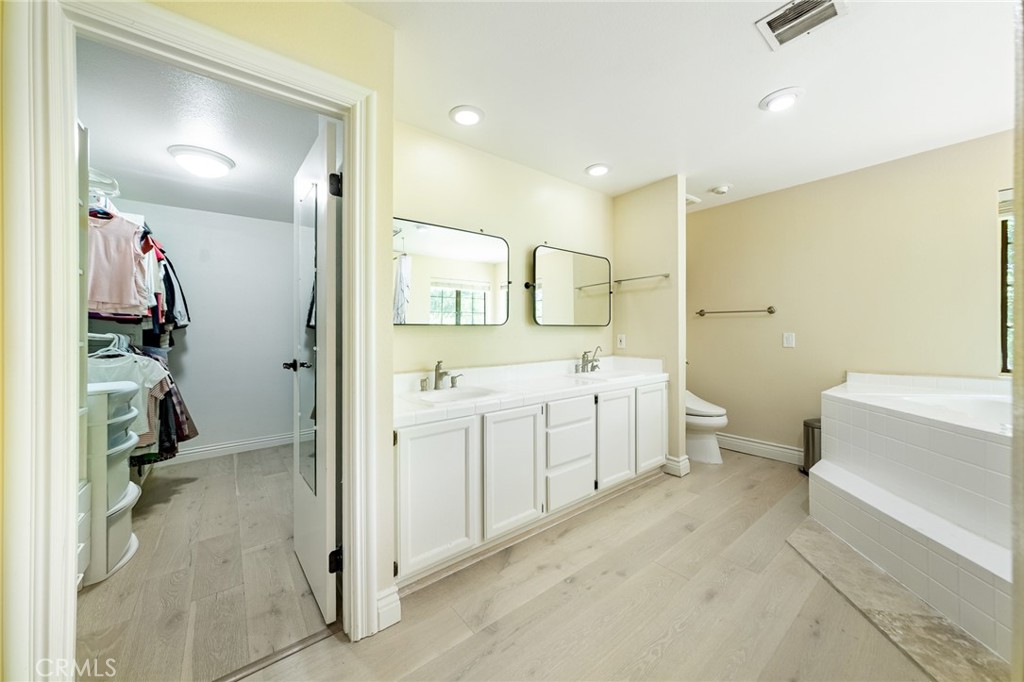 15601 Saddleback Road Canyon Country, CA 91387 - Photo 26 of 55 a bathroom with a double vanity sink toilet tub and shower