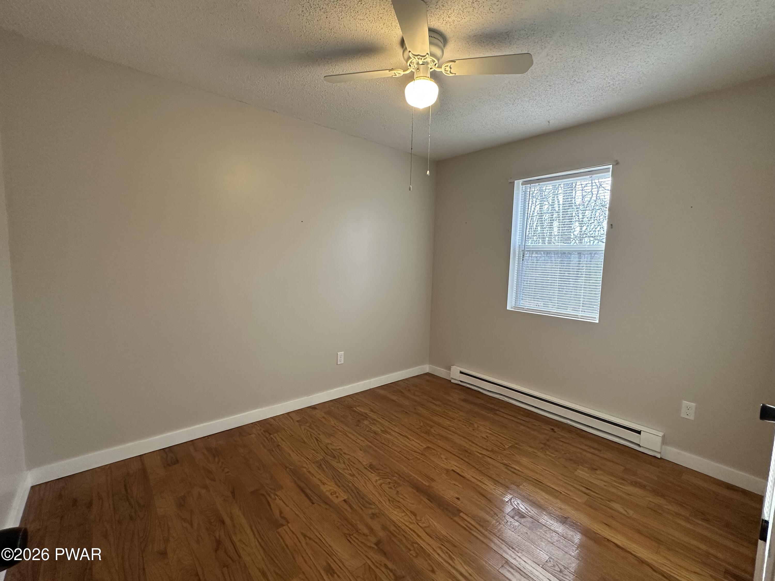 2116 Spring Drive Bushkill, PA 18324 - Photo 10 of 19 a view of empty room with wooden floor and fan