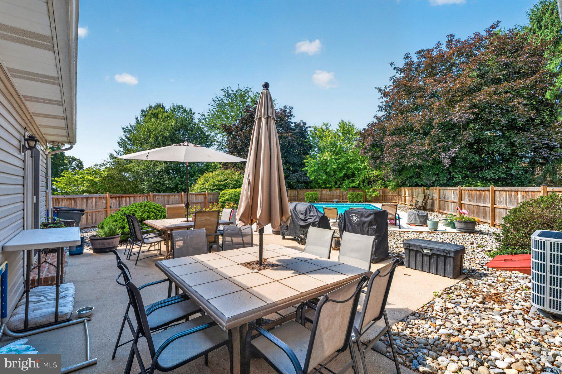 49 Rockland Road Westminster, MD 21158 - Photo 23 of 66 a view of a patio with a dining table and chairs with a small yard