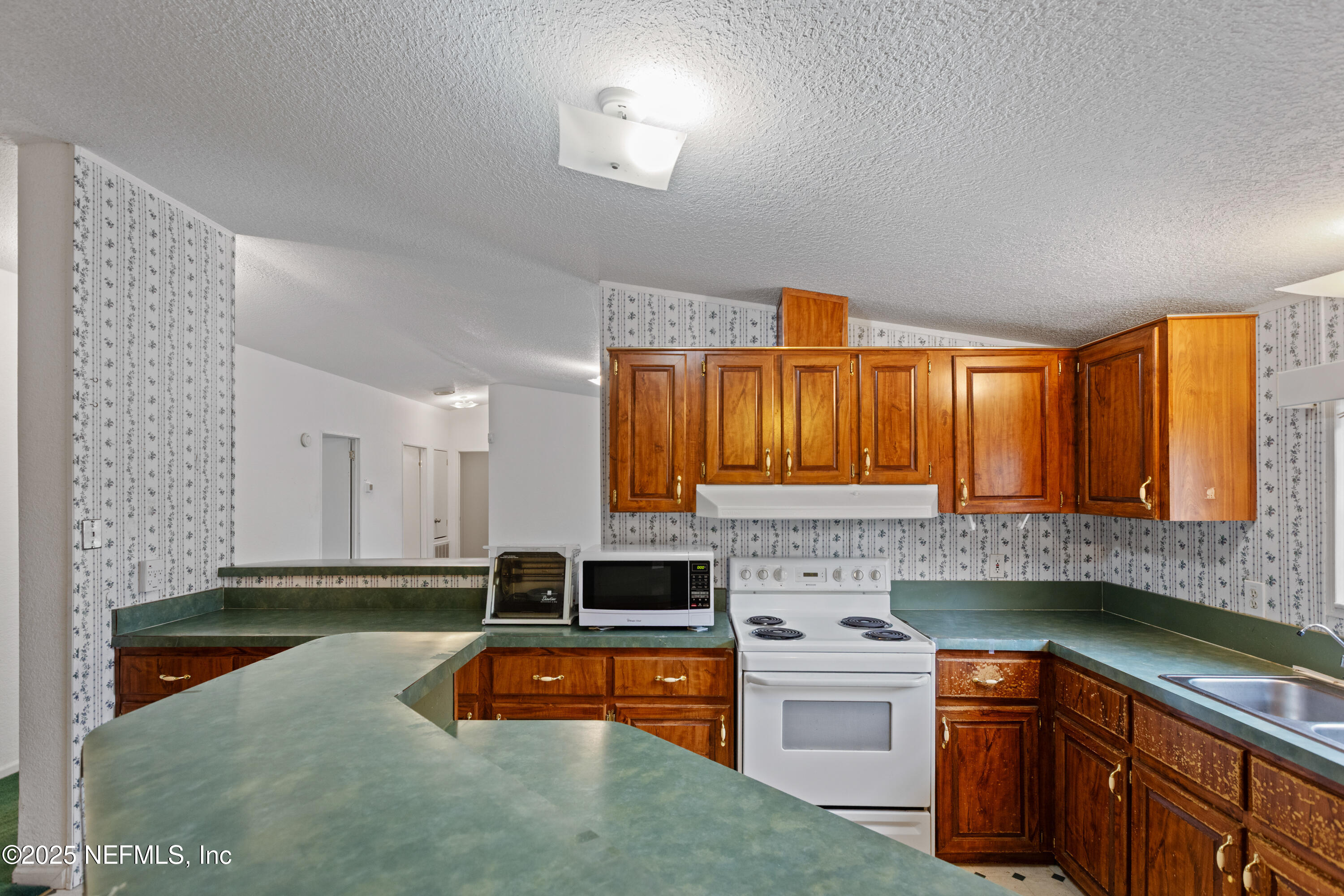 5750 Sequoia Road Keystone Heights, FL 32656 - Photo 11 of 33 a kitchen with stainless steel appliances granite countertop a stove a sink and a microwave
