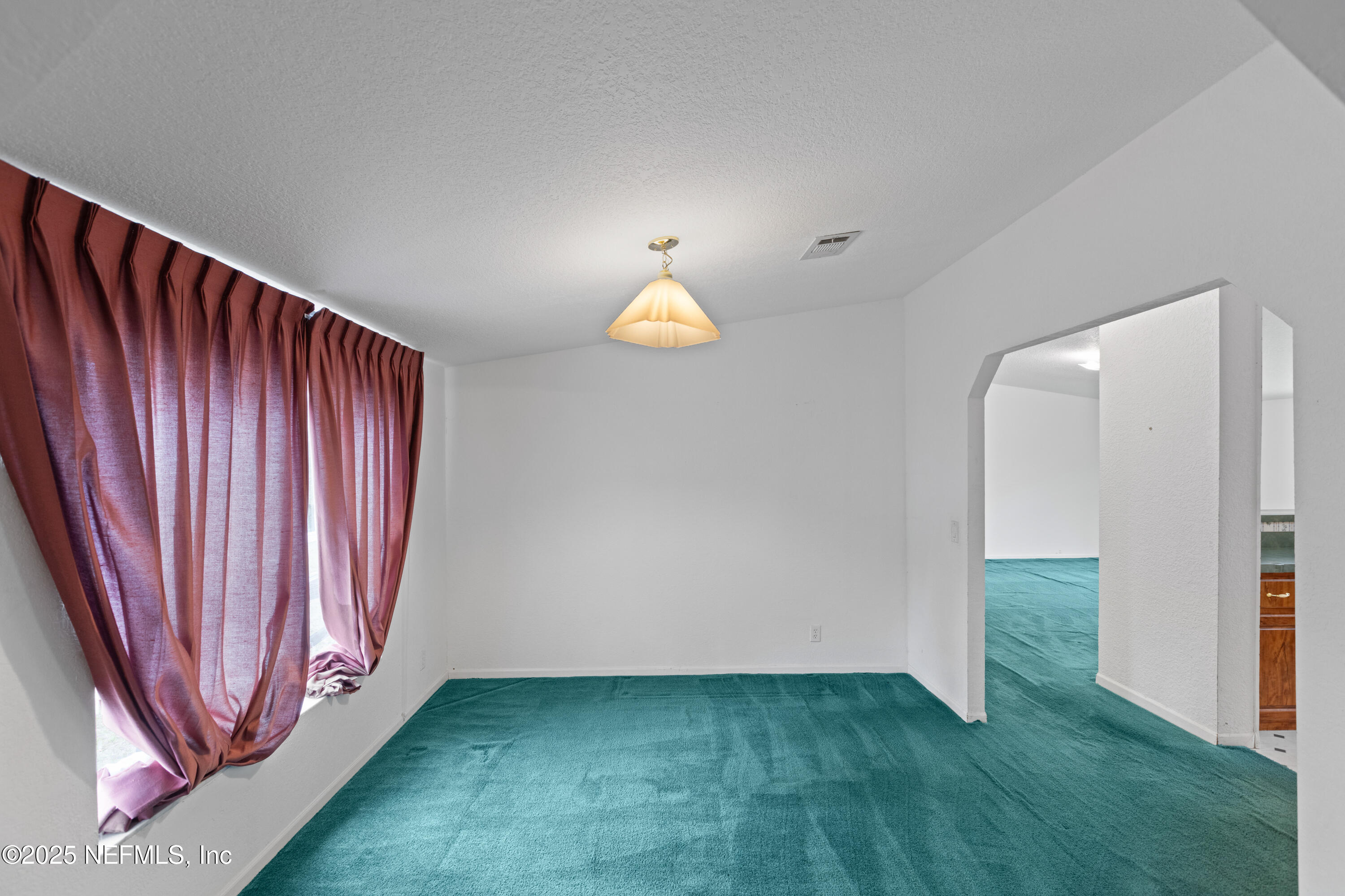 5750 Sequoia Road Keystone Heights, FL 32656 - Photo 16 of 33 a view of an empty room with window and a kitchen