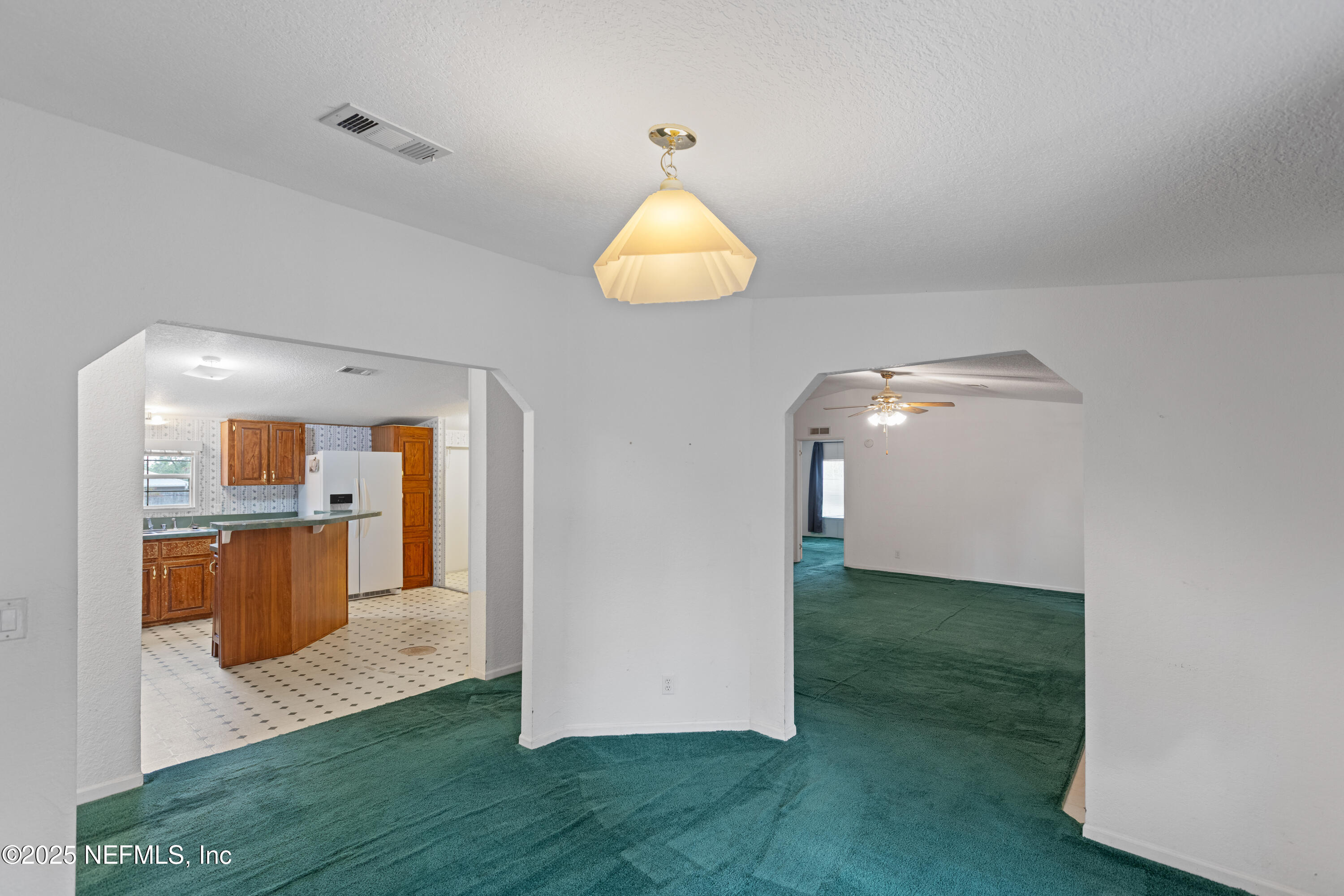 5750 Sequoia Road Keystone Heights, FL 32656 - Photo 18 of 33 a view of a room with kitchen island stainless steel appliances wooden floor and window