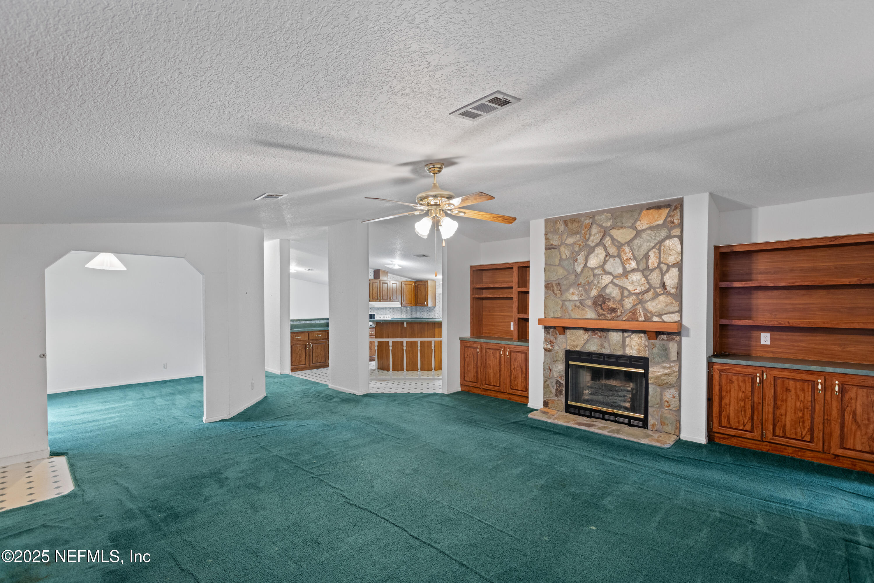 5750 Sequoia Road Keystone Heights, FL 32656 - Photo 9 of 33 a living room with fireplace furniture and a open kitchen view