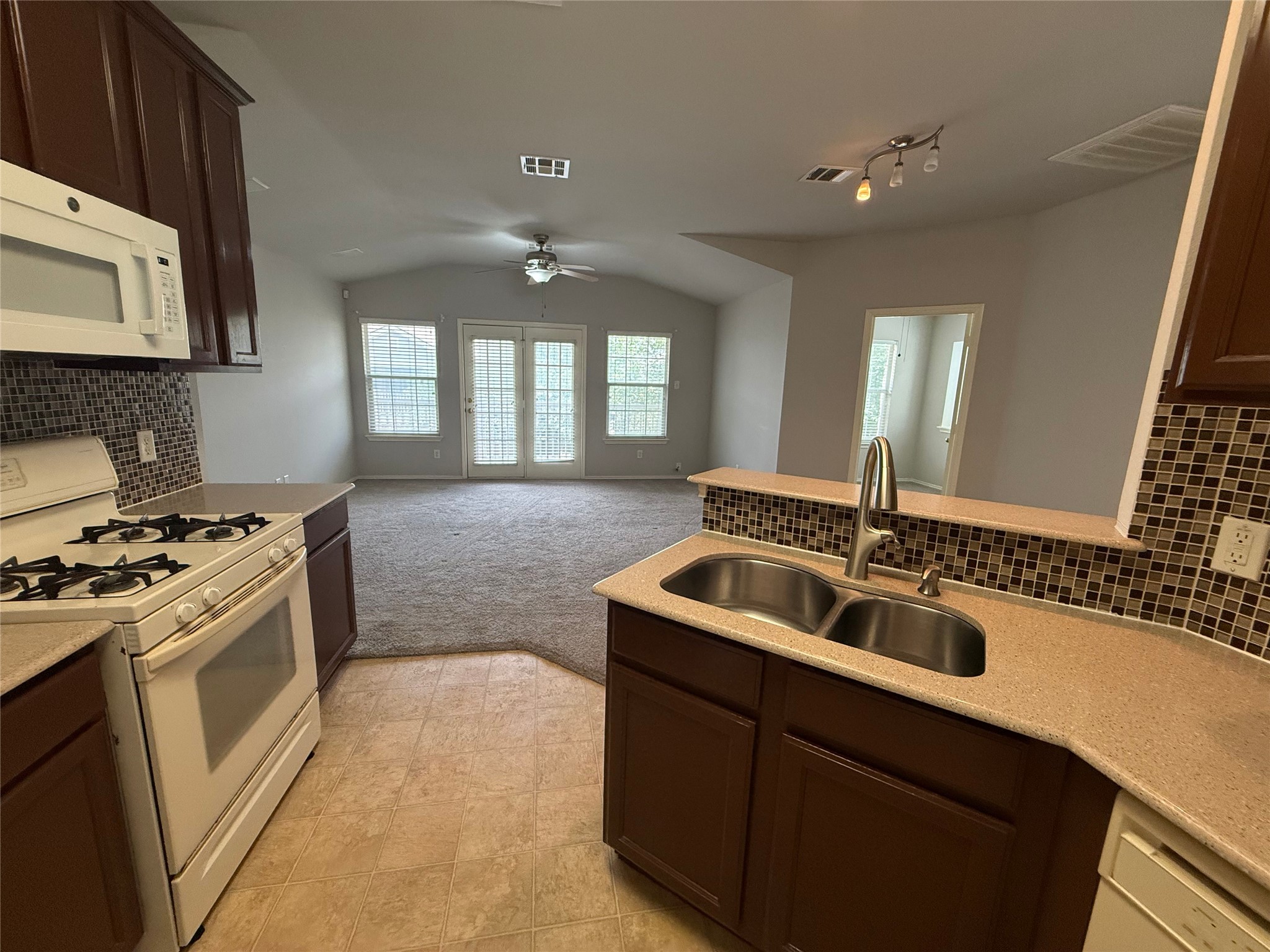 1900 Scofield Ridge Parkway, Unit 4701 Austin, TX 78727 - Photo 14 of 27 An inviting kitchen seamlessly flows into a spacious living area, ideal for entertaining.