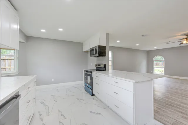 a view of kitchen with sink microwave and stove