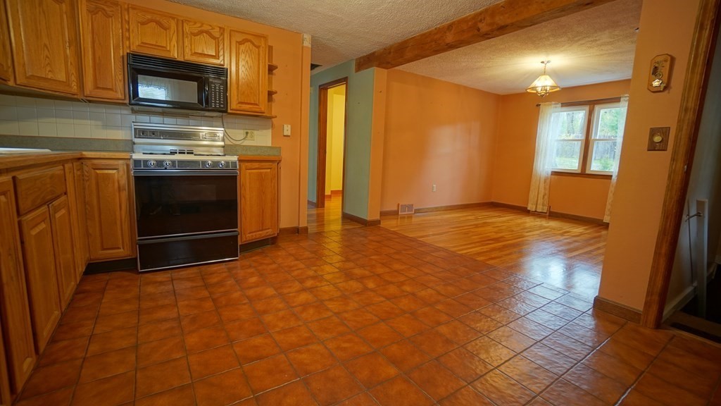 32 North Brook Road Springfield, MA 01119 - Photo 2 of 17 a view of empty room with kitchen and fireplace
