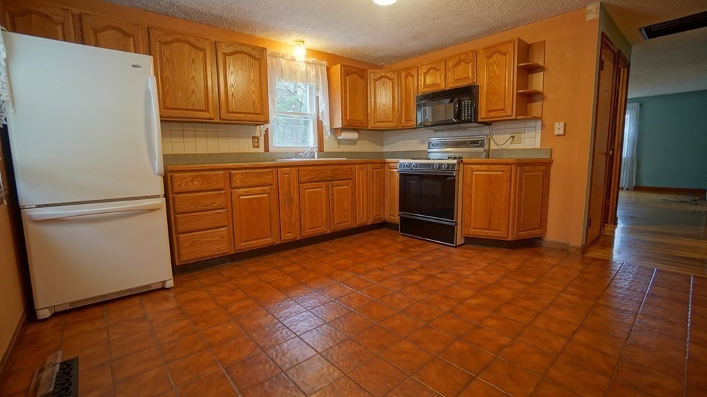 32 North Brook Road Springfield, MA 01119 - Photo 3 of 17 a kitchen with stainless steel appliances granite countertop a refrigerator sink and cabinets