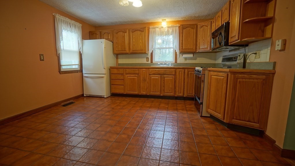 32 North Brook Road Springfield, MA 01119 - Photo 4 of 17 a kitchen with stainless steel appliances a refrigerator and a sink