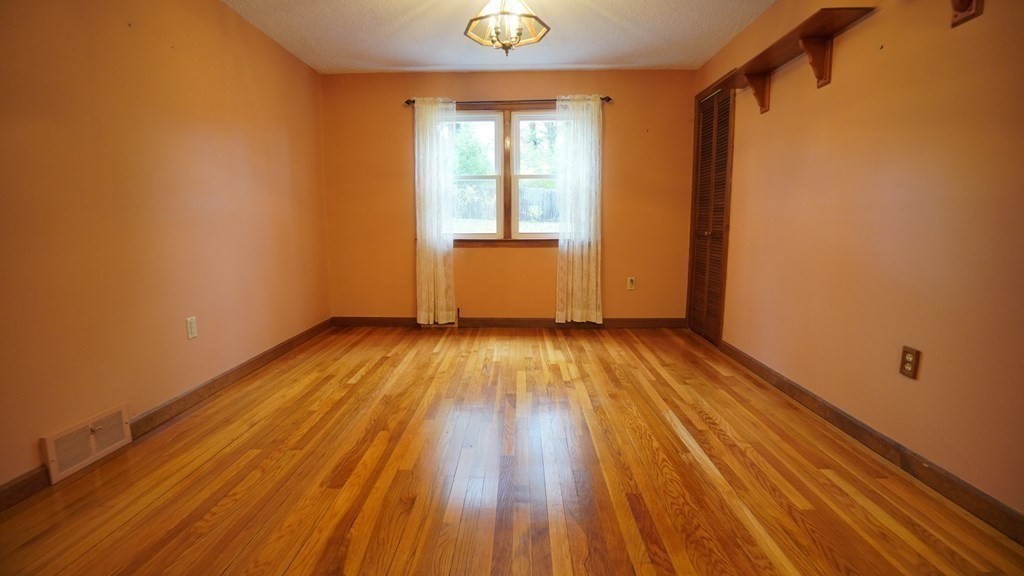 32 North Brook Road Springfield, MA 01119 - Photo 5 of 17 a view of empty room with wooden floor and fan