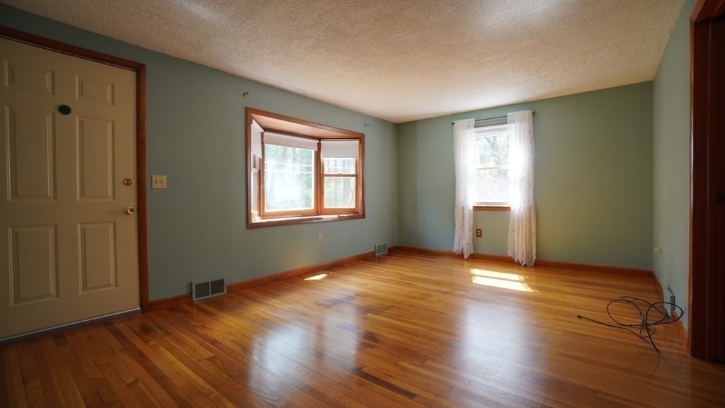 32 North Brook Road Springfield, MA 01119 - Photo 8 of 17 an empty room with wooden floor and windows