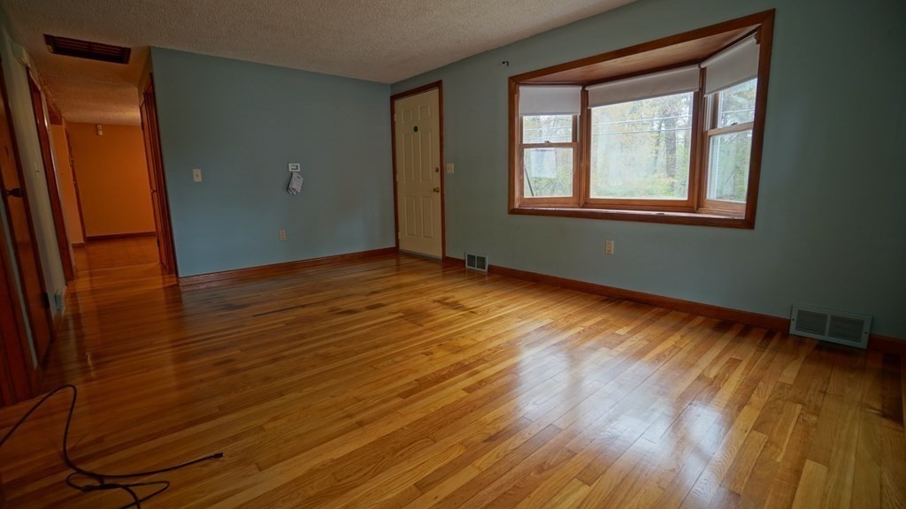 32 North Brook Road Springfield, MA 01119 - Photo 9 of 17 a view of an empty room with wooden floor and a window