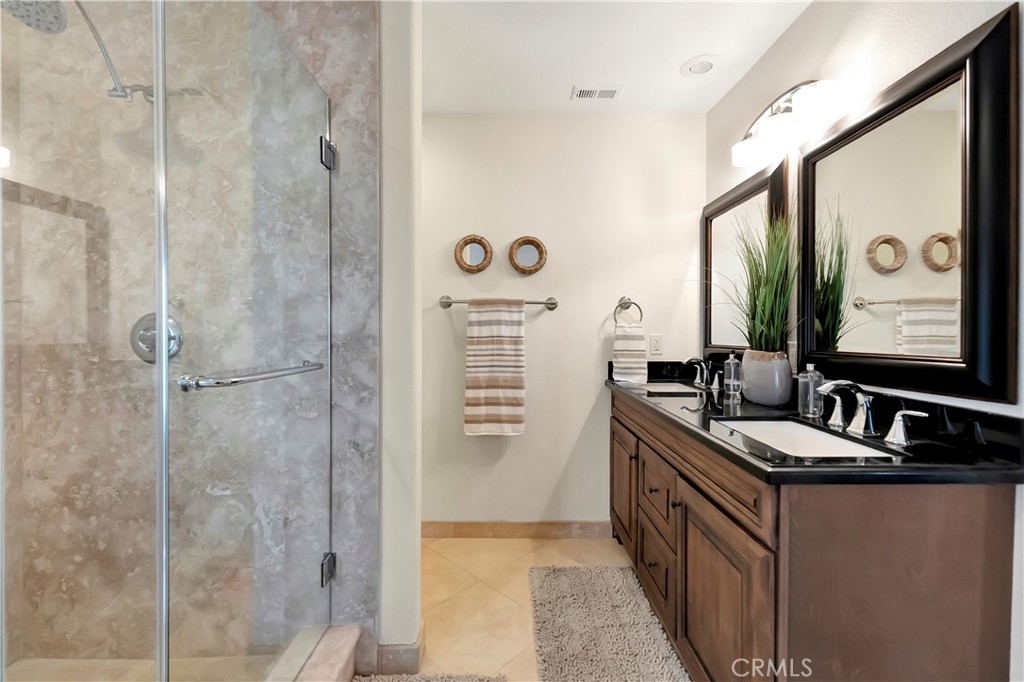 621 8th Street Huntington Beach, CA 92648 - Photo 37 of 56 a bathroom with a double vanity sink a mirror a window and a shower