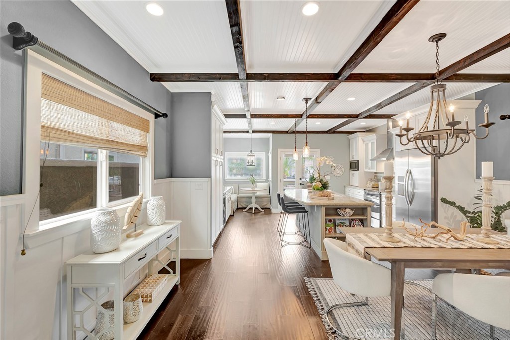 621 8th Street Huntington Beach, CA 92648 - Photo 9 of 56 a view of a dining room with furniture a chandelier and wooden floor