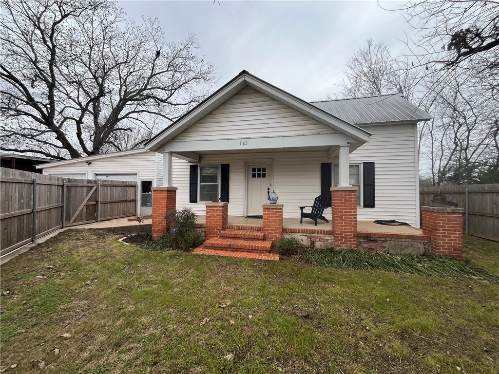1102 North Travis Avenue Cameron, TX 76520 - Photo 46 of 48 View of front of property with a porch and a metal roof