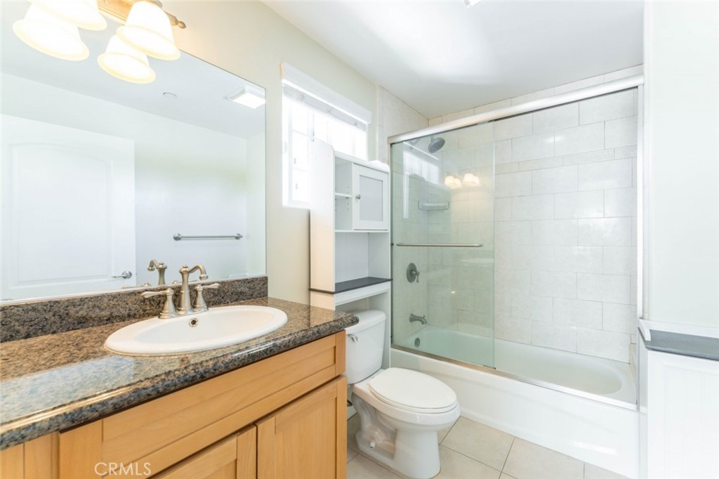 511 East Harvard Road, Unit 101 Burbank, CA 91501 - Photo 23 of 29 a bathroom with a shower sink vanity mirror and toilet
