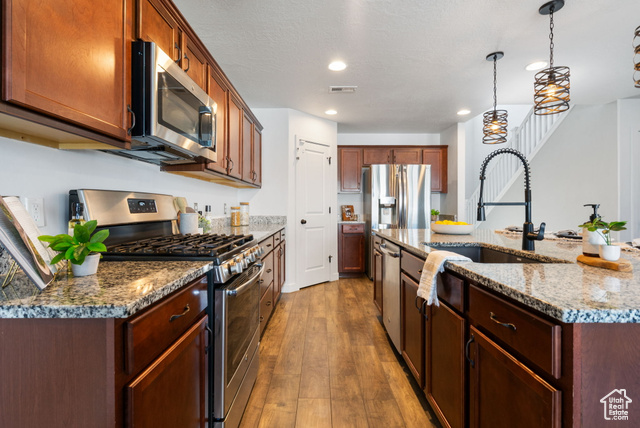 3456 South Linden Way Syracuse, UT 84075 - Photo 10 of 50 Kitchen with appliances with stainless steel finishes, a sink, hardwood / wood-style flooring, recessed lighting, and decorative light fixtures