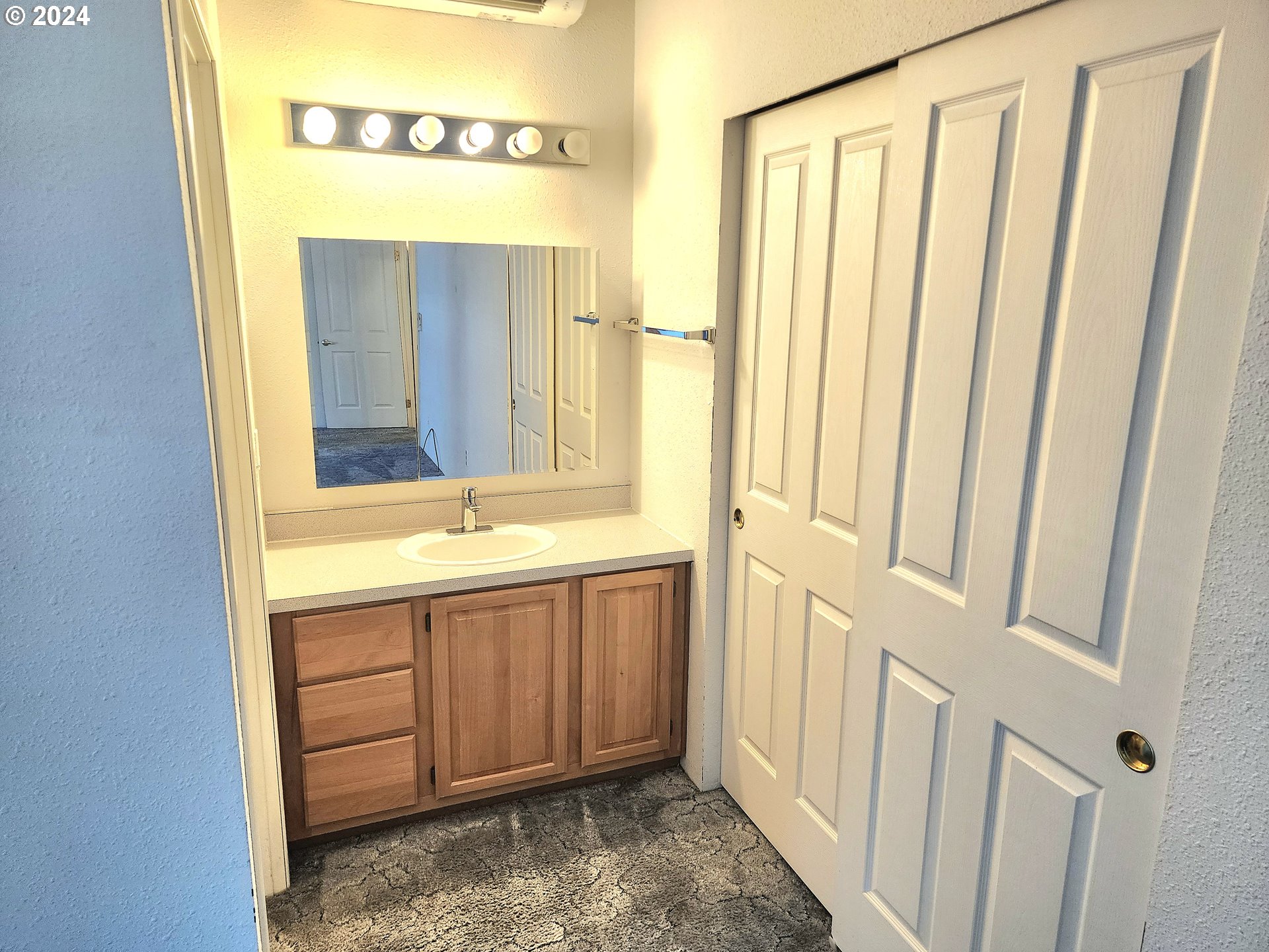 1475 Green Acres Road, Unit 69 Eugene, OR 97408 - Photo 12 of 15 a bathroom with a sink a mirror and a bathtub