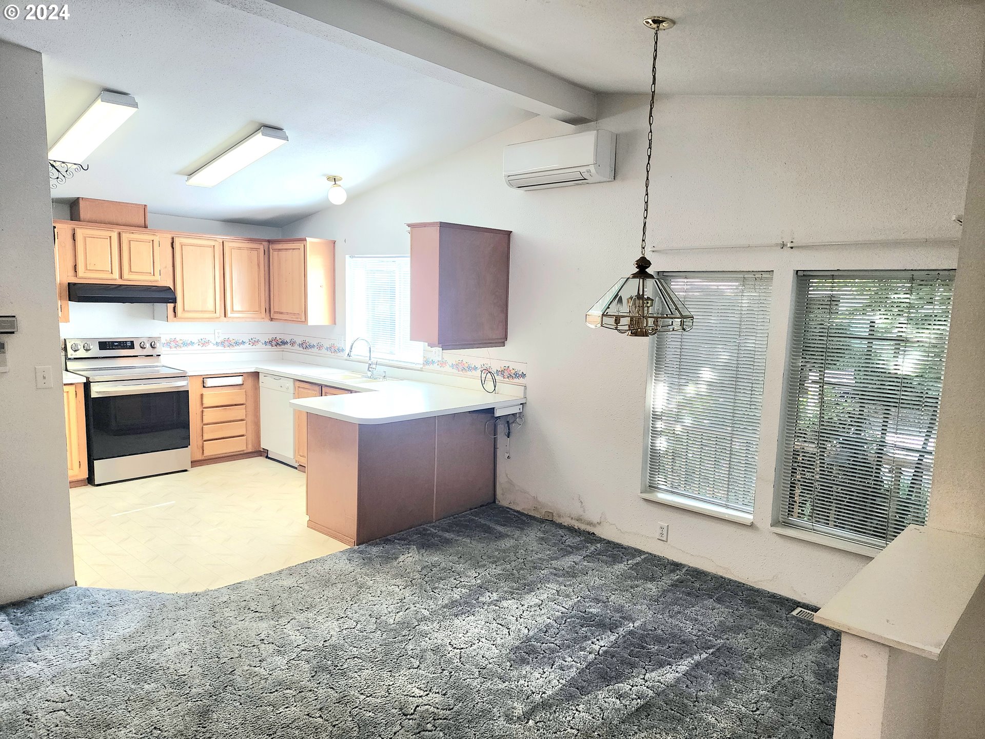 1475 Green Acres Road, Unit 69 Eugene, OR 97408 - Photo 8 of 15 a kitchen with a stove a sink and a refrigerator