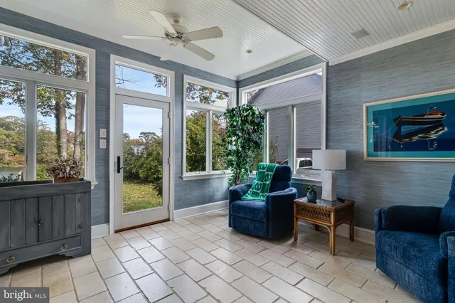 a living room with fireplace furniture and a large window