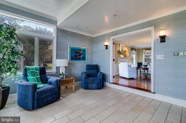 a living room with furniture a fireplace and a potted plant