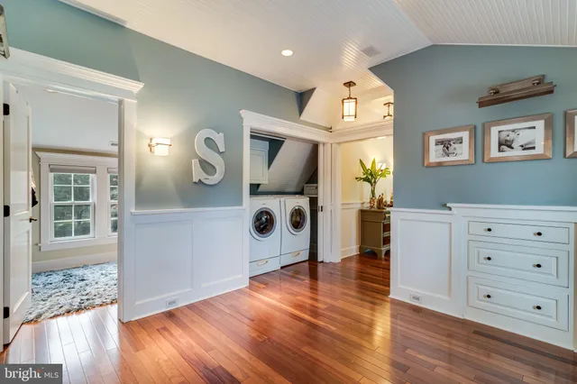 a front view of a house with a garden and yard