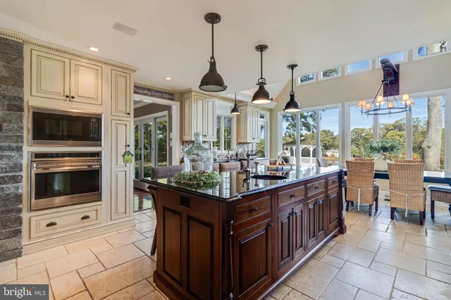 a view of a dining room with furniture large windows and wooden floor