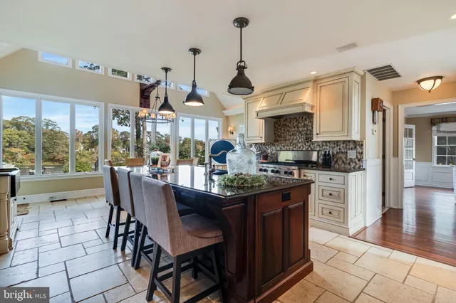a kitchen with stainless steel appliances a stove a sink and a refrigerator