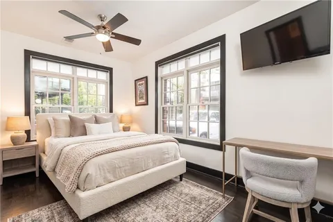 a large bedroom with a bed wooden floor and window