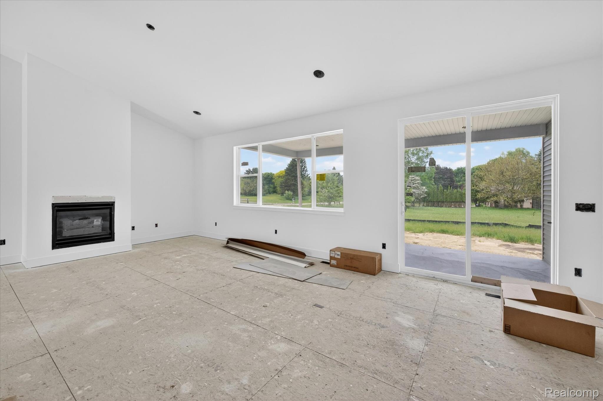 3297 Oak Grove Road Howell, MI 48855 - Photo 5 of 40 Spacious open-concept living area with abundant natural light and doorwall access to covered patio.