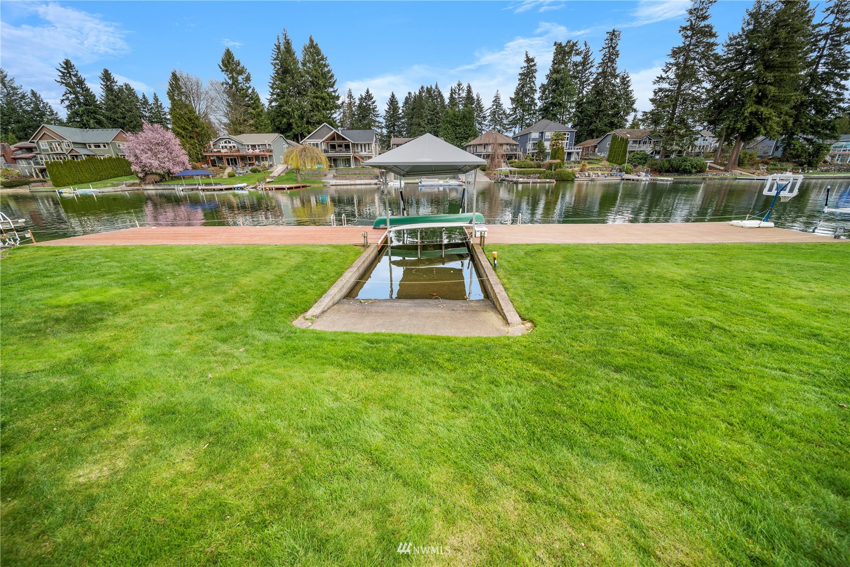 1919 Channel Road East Lake Tapps, WA 98391 - Photo 23 of 33 a front view of a house with a yard table and chairs