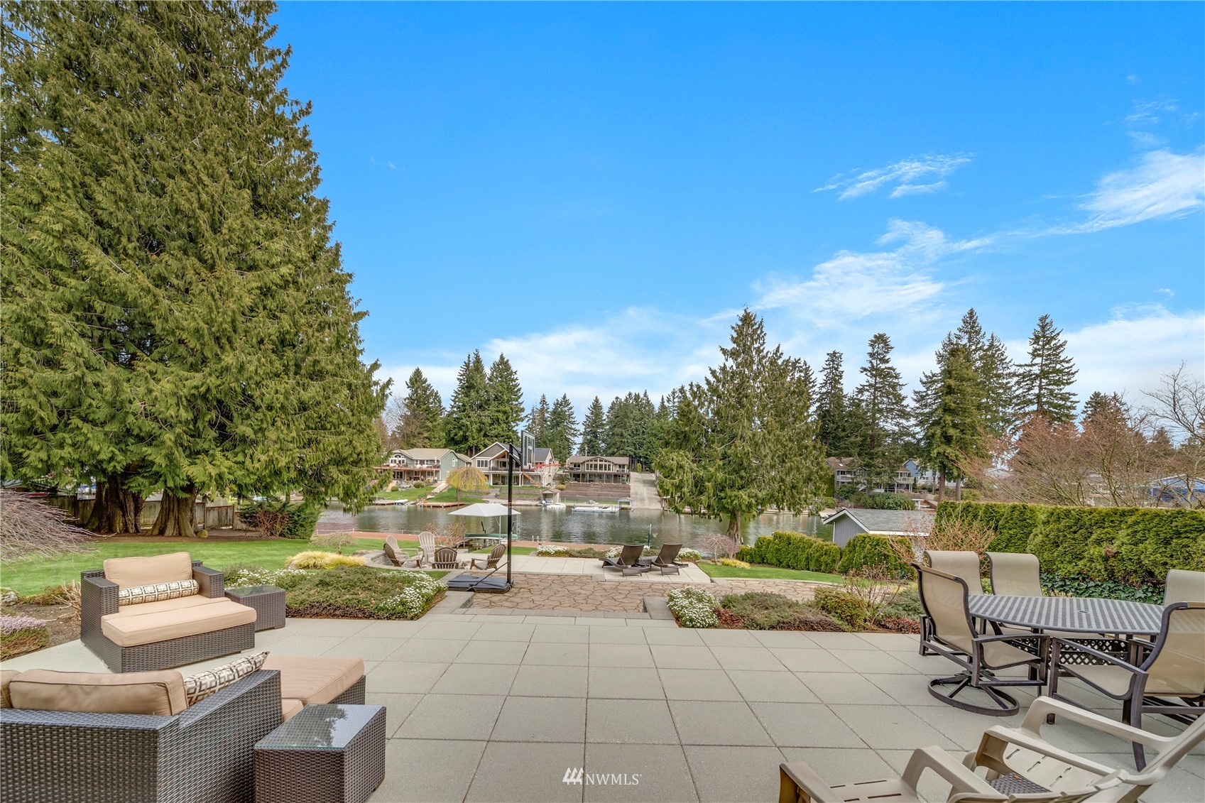 1919 Channel Road East Lake Tapps, WA 98391 - Photo 29 of 33 a view of a patio with couches and table and chairs and potted plants