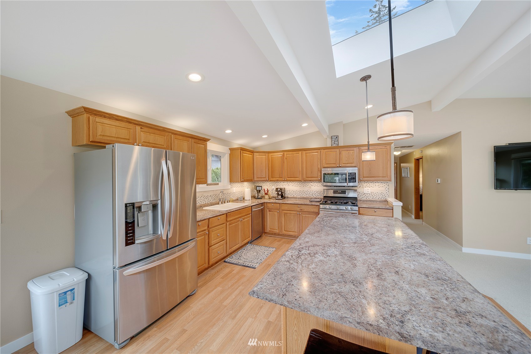 1919 Channel Road East Lake Tapps, WA 98391 - Photo 9 of 33 a kitchen with stainless steel appliances granite countertop a refrigerator a sink and a stove
