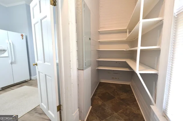 a view of walk in closet with empty racks